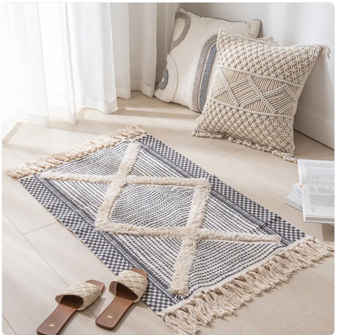 Contemporary minimalist area rug by Limestoneshop featuring neutral tones and simple geometric patterns on soft fabric.