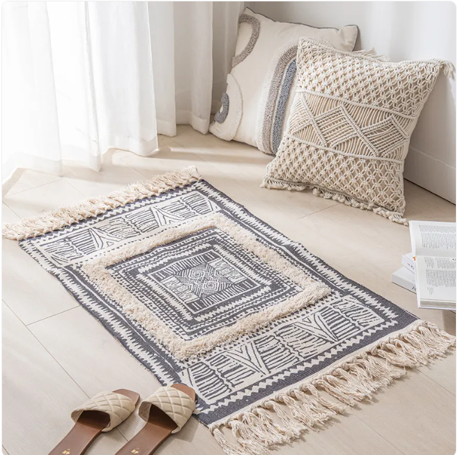 Contemporary minimalist area rug by Limestoneshop with neutral tones and simple geometric design on soft woven fabric.